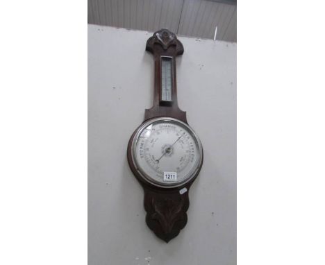 An oak aneroid barometer.