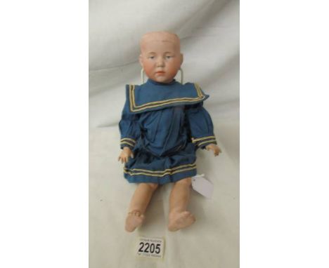 A porcelain headed doll marked K & R - 101, missing wig, 38 cm. ****Condition report**** There are marks on the back of head,