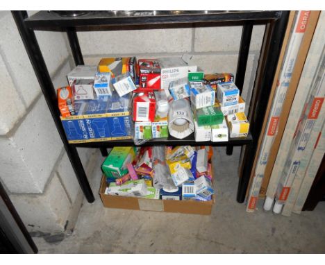 A large quantity of various sized light bulbs on 2 shelves plus strip lights, collect only