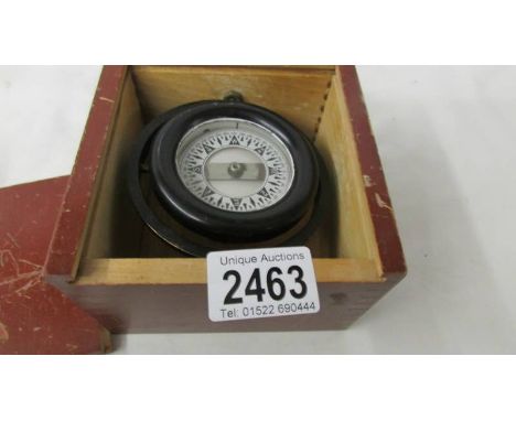 A boxed small marine compass.