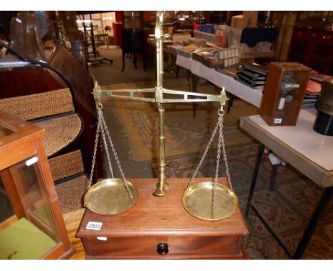 A cased set of brass scales.