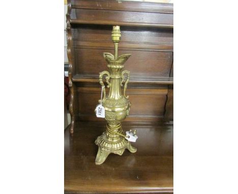 An ornate brass table lamp.