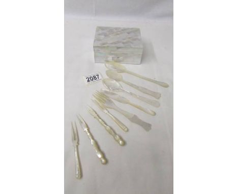 A mother of pearl box, 3 spoons, a butter knife, fork and 4 pickle forks.