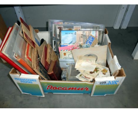 An interesting box of ephemera including vintage postcards and photographs, cigarette cards, silks, booklets, stamp albums an