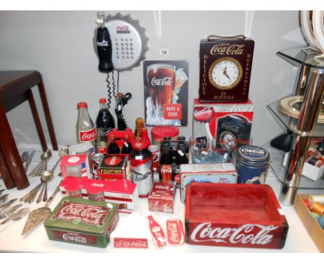 A large quantity of Coca Cola items, including glasses, clock telephone, tooth pick holder, napkin holder, key holder etc.