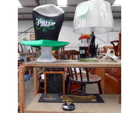 A Guinness Carlton Ware lamp a/f, hat, bar runner and pump emblem