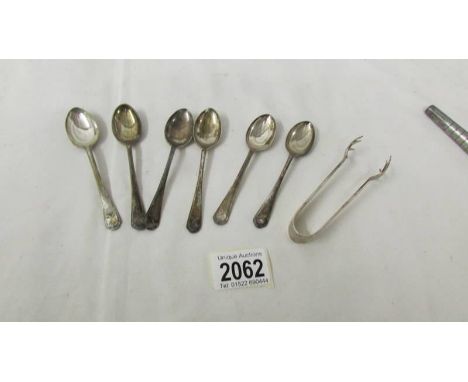 A set of 6 golf related silver tea spoons and silver sugar nips.