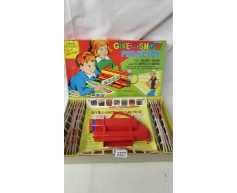 A Chad Valley third edition Give a Show projector complete with colour slides.