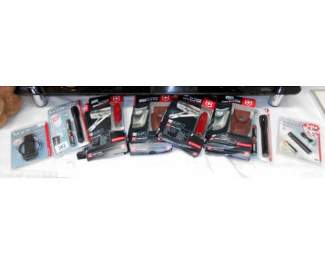 2 boxed Victorinox 33 function Swiss Champ Army knives and 2 leather pouches and quantity of mini maglite torches in sealed p