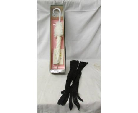 A boxed vintage bridal parasol and a pair of long black gloves.