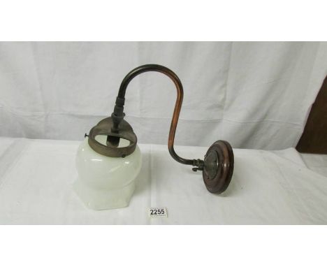 An early 20th century gas wall light with opaque glass shade.
