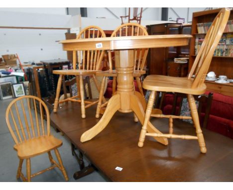 A round light oak kitchen table on centre column with 4 chairs diameter 100cm x height 74cm