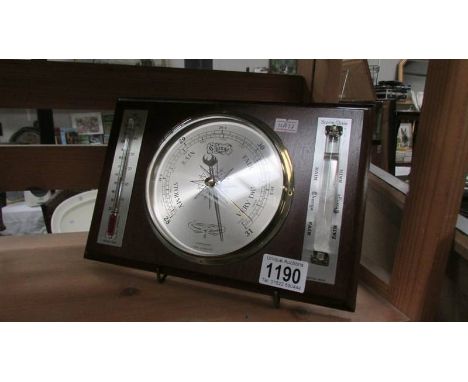 A modern barometer/thermometer.
