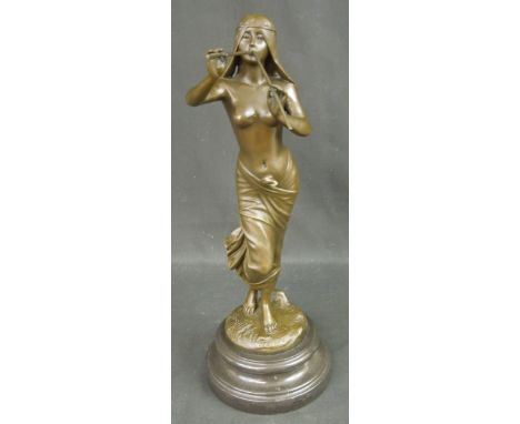 AFTER THE ANTIQUE, A PATINATED BRONZE FIGURINE OF A PIPE PLAYING MAIDEN.  Quality Bronze Assurance foundry seal.  Grey marble