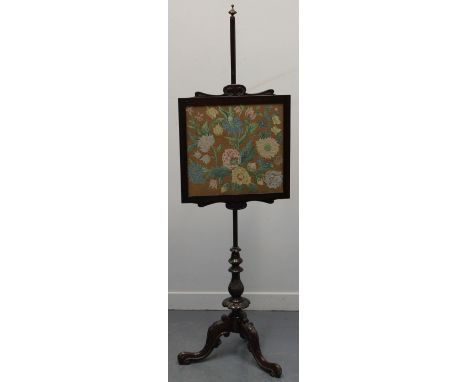 LATE VICTORIAN MAHOGANY POLE SCREEN having square tapestry banner with scroll moulded cresting on a triform base with moulded