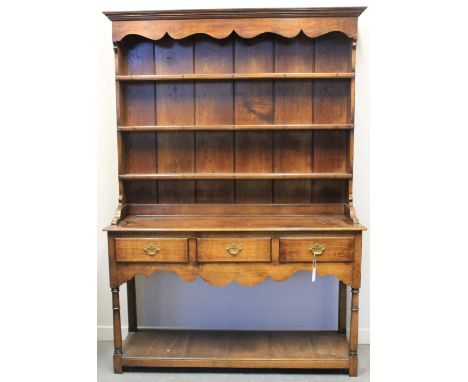 18TH CENTURY STYLE OAK WELSH DRESSER, having moulded cornice above three shelf boarded rack, the base with three frieze drawe