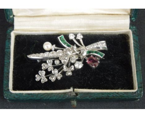 A FLORAL BROOCH set with diamonds, ruby and emerald and pearl.  The main floral spray set with old cut and rose cut diamonds,