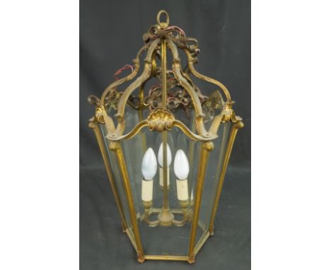 LATE 19TH/EARLY 20TH CENTURY YELLOW METAL SHELL AND SCROLL DESIGN, HEXAGONAL, TAPERING HALL LANTERN, having six section glass
