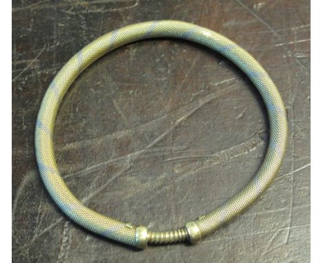 A 15CT TWO COLOUR GOLD MESH EXTENDABLE BANGLE.  Yellow gold with bands of white gold.  Weight 20.3g CONDITION REPORT: Stamped