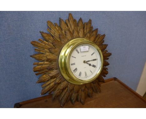 A Baskerville sunburst wall clock, a/f 