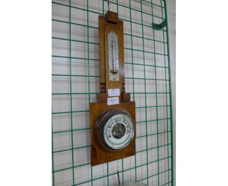 An Art Deco oak aneroid barometer 