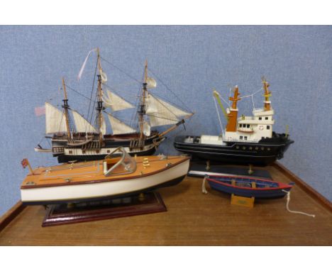 A limited edition scale model of H.M.S. Beagle, a model of a sailing tug and two other boats 