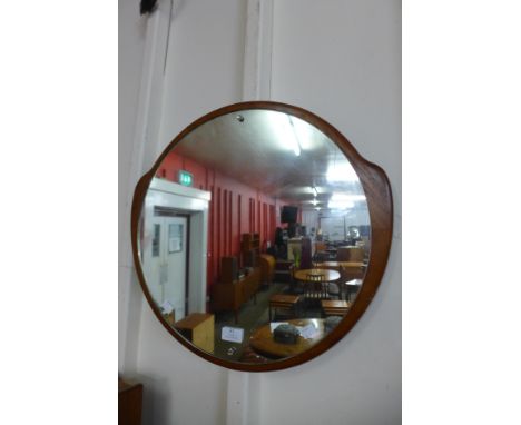 A teak framed circular mirror 