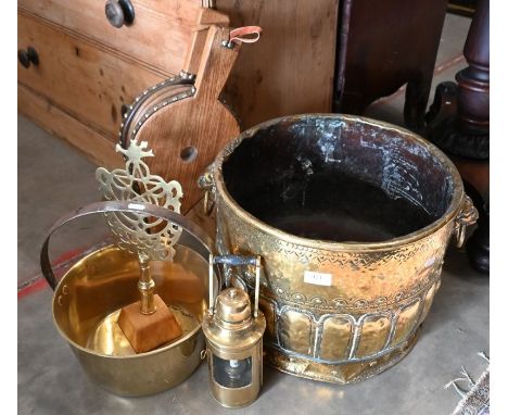 An antique brass coal/log bucket with embossed and engraved decoration and lion mask ring handles, 31 cm h x 42 cm dia to/w h