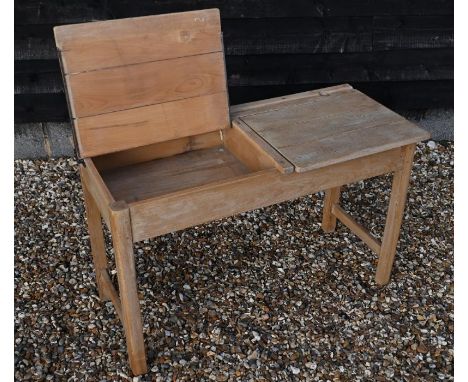 A vintage light oak double school desk with twin-hinged panelled top, 102 cm wide x 46 cm deep x 64 cm high