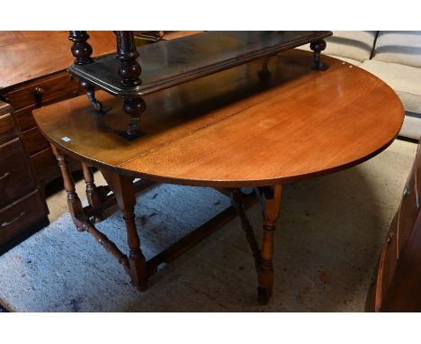 A large Ipswich quality (possibly Titchmarsh &amp; Goodwin) oak drop leaf dining table in the mid 17th century style on a tur