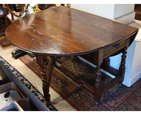 A 17th century style oak drop leaf gateleg table raised on a part bobbin turned frame, 122 x 148 cm (open) x 75 cm high