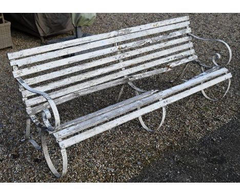 An old wrought steel and wooden slat garden bench for renovation