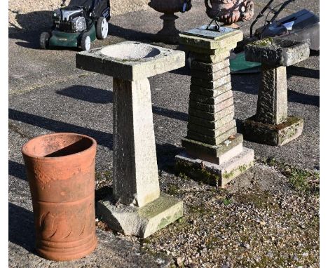Two weathered stone bird baths to/w an obelisks mounted wtih a verdigris patinated sundial and one terracotta chimney pot (4)