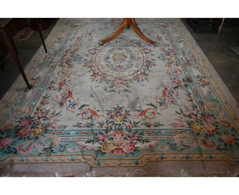 A Chinese cut wool carpet, floral design on peach ground, light blue border, 340 x 245 cm&nbsp;