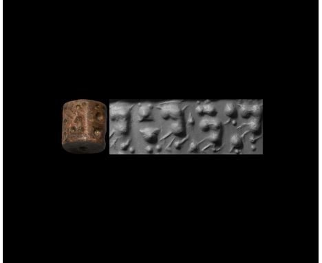 31st-30th century BC. A large brown stone cylinder seal, drilled vertically for suspension; accompanied by a museum-quality i