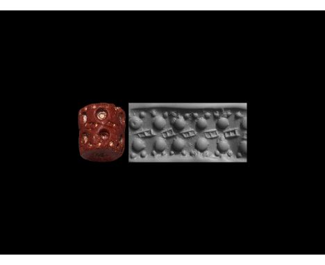 4th-3rd millennium BC. A red stone cylinder seal, pierced vertically for suspension; accompanied by a museum-quality impressi