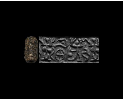 16th-10th century BC. A large black serpentine seal, drilled vertically for suspension; accompanied by a museum-quality impre