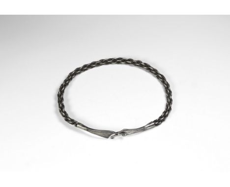 9th-10th century AD. A silver neck-ring with body formed of braided silver rods and applied ropework wires between, hook-and-