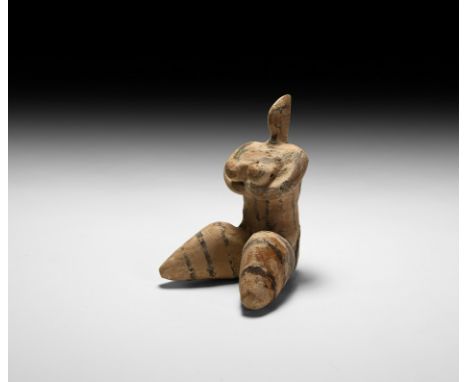 Early 6th millennium BC. A ceramic figure formed as a seated mother goddess; pinched triangular-profile head, arms held to th
