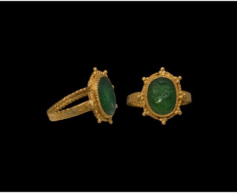 2nd-3rd century AD.&nbsp;A gold ring with bifacial 'barley' hoop supporting oval bezel with ropework border and eight cluster