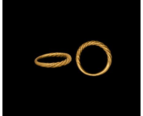 9th-11th century AD. A gold finger ring with the tapering shank formed as two twisted rods with punched pellet detailing. Cf.