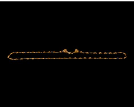3rd-1st century BC. A necklace composed of gold and lapis lazuli spool-shaped beads, all with gold loops and links; each term