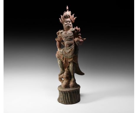Tang Dynasty, 618-906 AD. A hollow-formed ceramic figure of a guard standing on the shoulders of a grotesque figure kneeling 