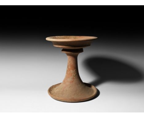 4th-3rd millennium BC. A ceramic chalice with carinated body above collar, tapering cylindrical stem and broad flared base wi