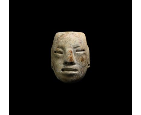 Classic Period, 5th-7th century AD. A carved alabaster mask depicting a naturalistic human face, probably a dignitary or rule