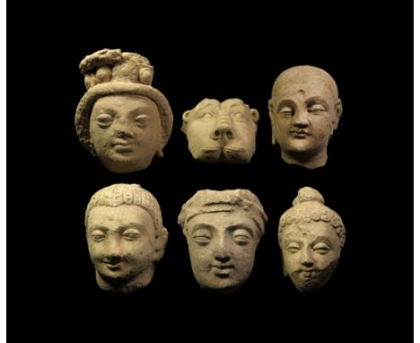 1st-5th century AD. A group of ceramic human and animal heads; one face of a lion with wrinkled nose, wide eyes, ears and det