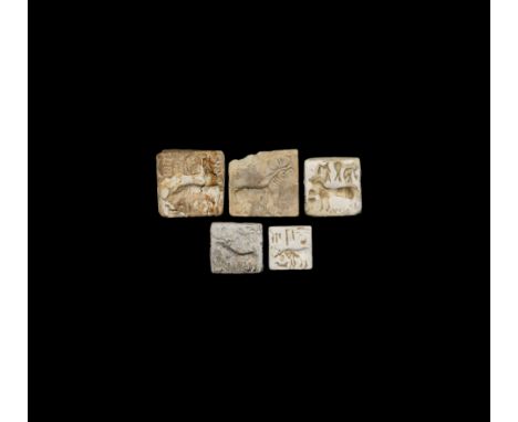 26th-19th century BC. A group of five ceramic stamp seals, each with a profile image of a bull with an inscription above. See