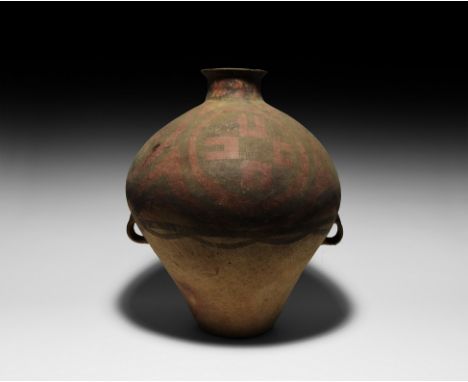 Late 4th-2nd millennium BC. A ceramic storage vessel with piriform body, everted rim, two integral lug handles and flat base;