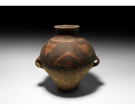 4th-3rd millennium BC. A ceramic piriform vessel with two integral lug handles, broad neck and everted rim; painted with a se