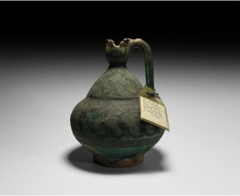 12th-13th century AD. A ceramic jug with piriform body, bell-shaped neck, round-section handle and deep foot; pained blue wit